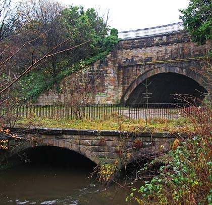 Now masked by trees, the two-arched culvert that escorted Luggie Water beneath both canal and railway.