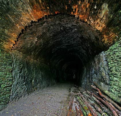 The central section of the tunnel is unlined. Both walls have ledges built into them at a height of around six feet.
