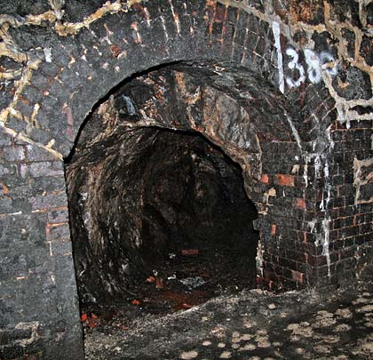 A small chamber extends a few feet back from the south wall, reputedly in connection with mining.