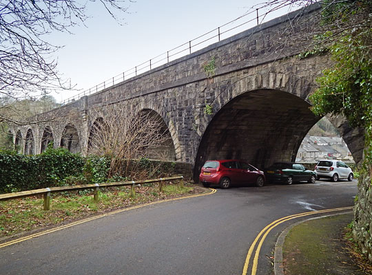 Cars parked under the easternmost arch, under which Quant Park passes.