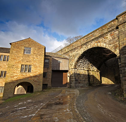 The viaduct runs alongside Higher Mill - now a textile museum - which predates the railway by 59 years.