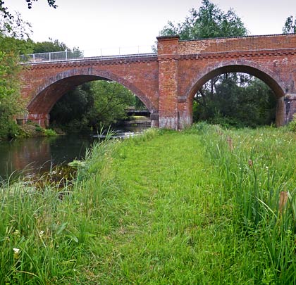 Towards the north end, a longer arch spans the River Itchen.