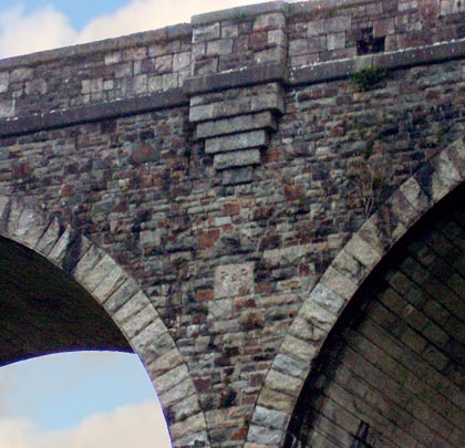 In the spandrel beneath one of the refuges is the viaduct's datestone.