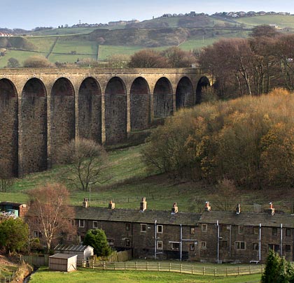 A row of cottages provide scale to the viaduct's southern arches.