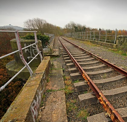 A single track still crosses the structure, slewed towards the centre of the trackbed as it approaches the southern abutment.