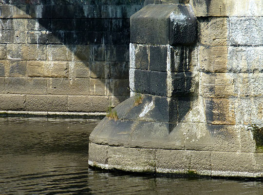 The piers comprise dressed stone blocks and are protected by modest cutwaters.