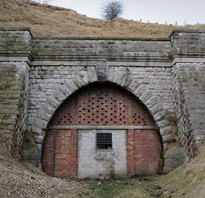 The tunnel was built for two tracks at its southern end, hence the portal's oversized appearance.