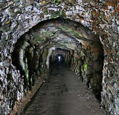 The north tunnel is largely unlined but has occasion masonry supports.
