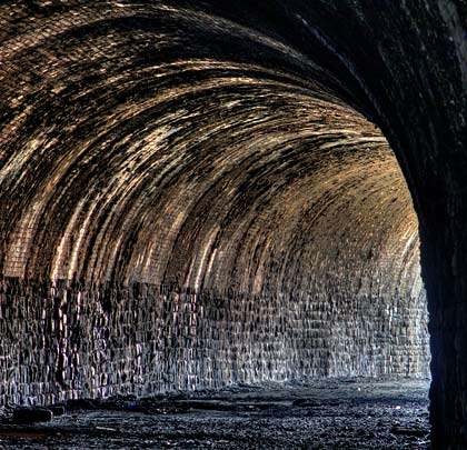 With masonry side walls and a brick arch, the tunnel incorporates a curve to the north of around 31 chains radius.