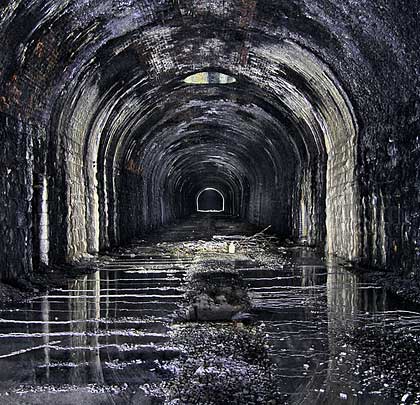 The bored part of the tunnel suffers from water ingress due to a broken field drain and features a ventilation shaft 30 feet deep.