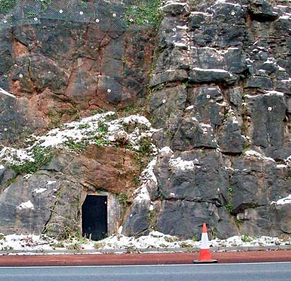 A doorway in the rock providing access into the tunnel at its midpoint.