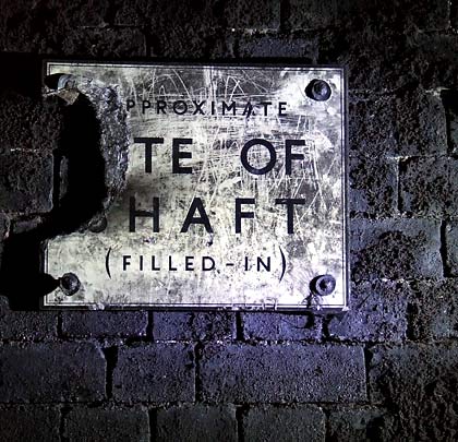 The location of an infilled construction shaft is marked by a sign.     This was a recommendation of the 1953 Clifton Hall Tunnel tragedy.
