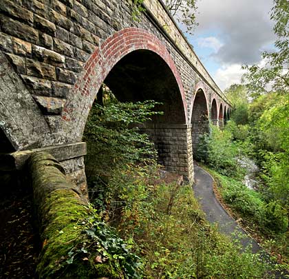 Two footpaths pass beneath the viaduct which now spans parkland.