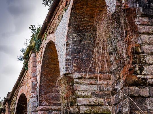 Vegetation has taken hold extensively on the viaduct's north side, blighting it with damaged brickwork. Sadly, despite its Grade II listing, some of this damage has been repaired unsympathetically.