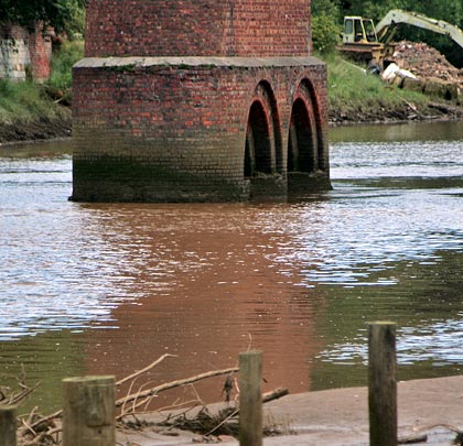 Presumably to help focus the load, the mid-water piers have arches cut through their feet.