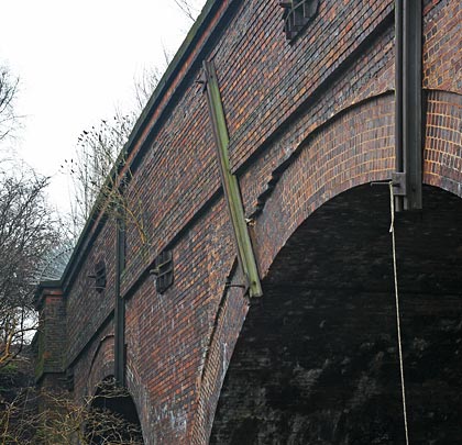 More defects on the north-west side where the spandrel/parapet is being pushed over the arch ring.