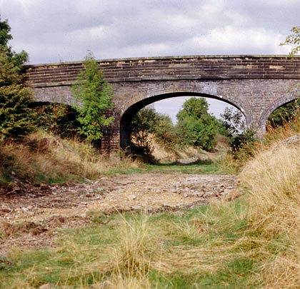 An unusual accommodation bridge with a masonry parapet.