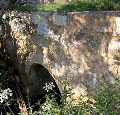 The entrance to a culvert immediately south of the former Ewesley Station, taking a watercourse under the railway and a road.