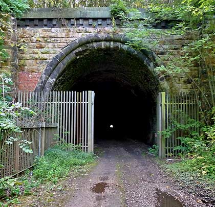 The northern portal makes less of a statement. Built originally in stone and with curved voussoirs, its appearance has been compromised by ugly red brick repairs and vegetation growth.
