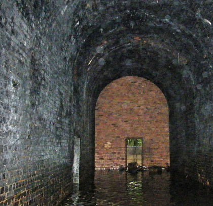 Standing water makes its presence felt at the north blockwall.