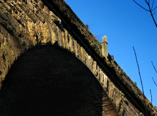 The remains of a signal post perches on the projecting cornice below the parapets.