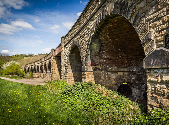 The arches spring off ashlar imposts above the piers.