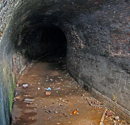 The brick-lined tunnel incorporates a tight S-shaped curve.