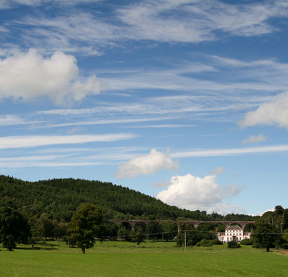 The viaduct blends into its surroundings behind an imposing mansion.