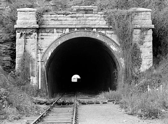 Vegetation was starting to consume the east portal in 1973. In front of it passed a line to the west breakwater which emerged from a tunnel camera-right.