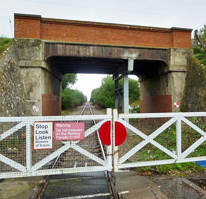 Today the station crossing is largely redundant as a bridge carries the main road over the running line.
