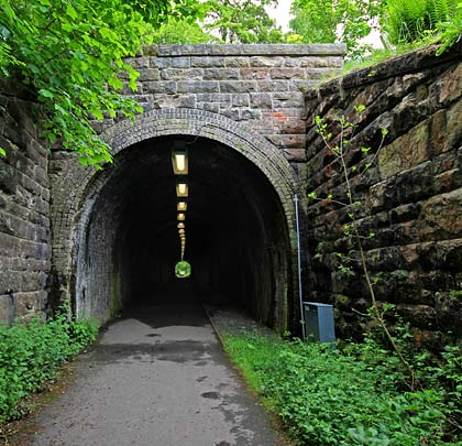 The west portal is a mirror of its eastern sibling, but its wing walls offer symmetry, being equal in length.