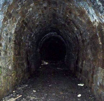 Stone lined, the tunnel is just over 50 yards long but has been blocked at its eastern end, robbing the interior of daylight.