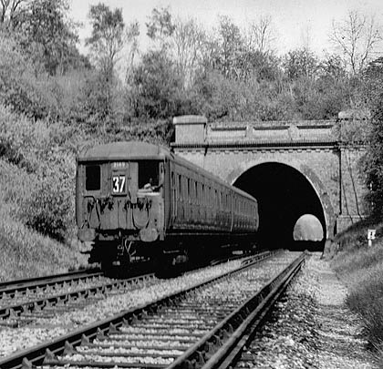 A two-car EMU enters the tunnel in May 1959.