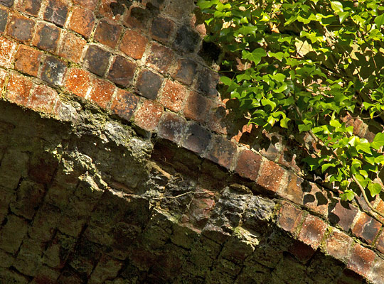 Some brickwork spalling and arch ring separation is apparent locally.