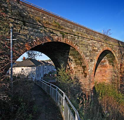 A footpath passes beneath the westernmost arch before climbing up the embankment to the viaduct's deck.