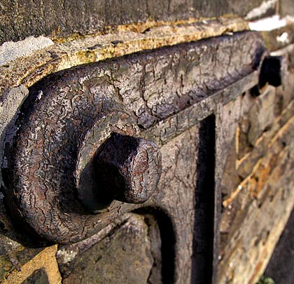 An anchor and tie bars hold in place the remains of a signal post.