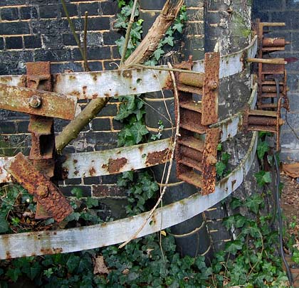 Rusting cable hangers adorn the brickwork.