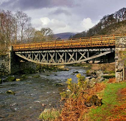 The first of two bridges across a small loop in the river, looking north towards Lonscale Fell on Skiddaw.