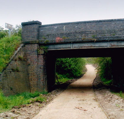 The extant bridge carrying Moira Road over the trackbed, a product of iron girderwork and engineering brick.