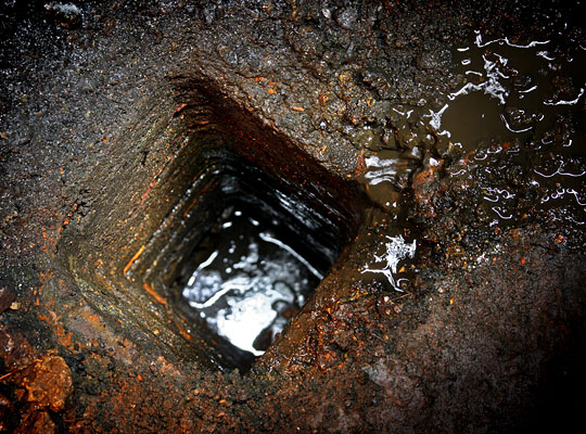 Water runs into a collection pit and enters a low-level drain.