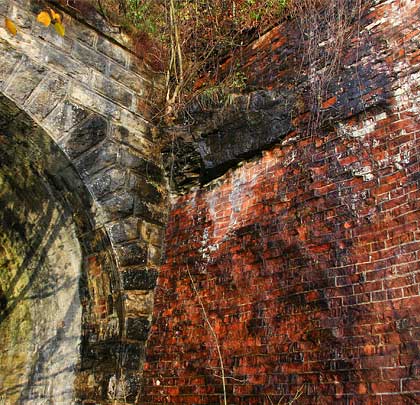 Adjacent to the south portal is a badly spalled brick retaining wall.