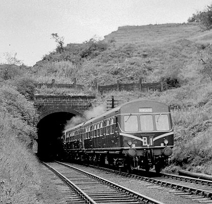 In August 1960, a Metro-Cammel DMU emerges from the east portal. Excavation work above the tunnel is almost complete.