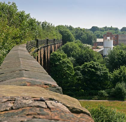 The curvature at the northern (near) end becomes more apparent in this view along the coped parapet towards Clifton Junction.