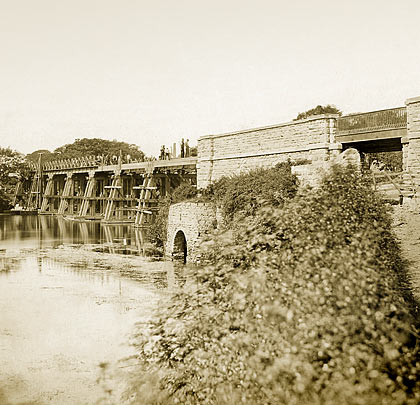 A deviation line was opened in 1872 bypassing the structure, requiring the construction of a timber viaduct near Hermitage Mill.