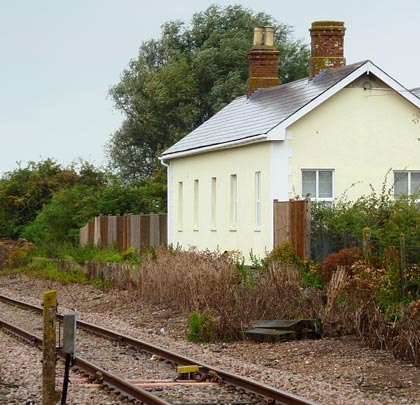 Closed in 1967, the householder at Brookland Halt - formerly part of the New Romney branch - can still 'enjoy' the regular spectacle of a train passing...carrying nuclear waste.