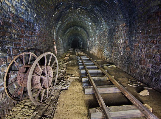 A section of narrow-gauge track in the straight, central part of the tunnel, laid on a concrete base.