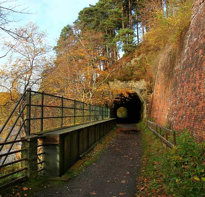 The approaches to the south portal are enhanced by the retaining wall - very substantial - and a short girder bridge. This view neatly shows the spur of land penetrated by the tunnel.