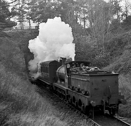 Having originated at Tenterden, 31064 leaves the tunnel with Headcorn in its sights on 28th November 1953.