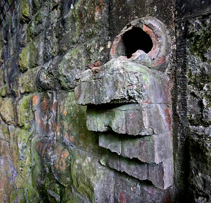 A drain emerges from the masonry.