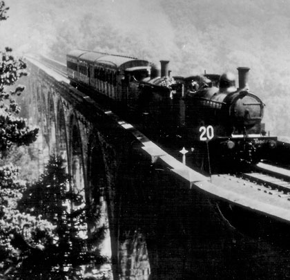 A three-carriage train heads south over the viaduct at a sedate 20mph.